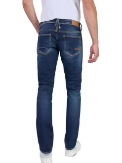 Jean en coton bleu indigo délavé aux genoux avec une coupe slim fit