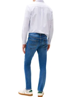 Jean en coton bleu uni avec une coupe slim à zip et à bouton