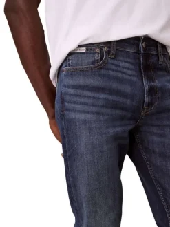 Jean en coton mélangé indigo uni avec une coupe slim à zip et bouton