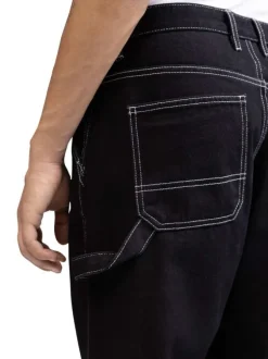 Jean en coton noir uni avec une coupe droite et des surpiqûres blanches
