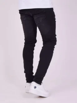 Jean en coton noir uni avec une coupe skinny et un effet troué