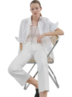Jean en lin blanc uni avec une coupe bootcut et des poches raglan à l'avant