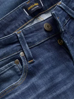 Jean Glenn bleu uni avec une coupe slim et des passants pour la ceinture