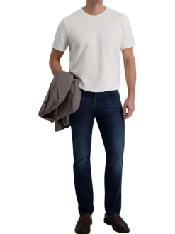 Jean indigo avec une coupe ajustée et une fermeture zippée avec un bouton
