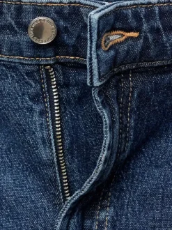 Jean 5 poches en coton indigo légèrement délavé avec une coupe bootcut