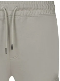 Jogging beige uni avec une coupe droite et deux poches latérales
