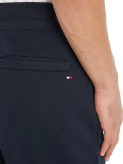Jogging marine uni avec une coupe slim et un lien de serrage à la taille