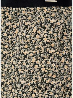 Jupe courte beige liberty avec une coupe droite et une taille noire élastiquée