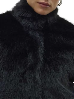Manteau noir uni en fourrure synthétique avec un col montant