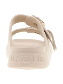 Mules écrues à semelle plate et un logo en relief sur le talon