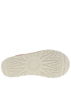 Mules en cuir sable avec un logo iconique embossé sur le côté
