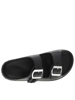 Mules noires à semelle plate et une fermeture à boucle à ardillon