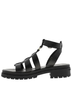 Nu-pieds en cuir noirs à semelle plat et à boucle à ardillon