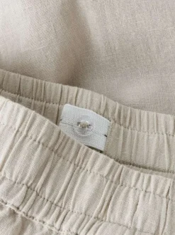Pantalon chino en lin et coton beige uni pourvu d'une taille élastiquée