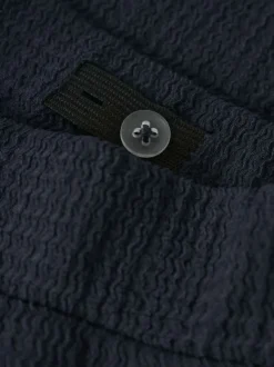 Pantalon chino marine uni pourvu d'une taille élastiquée et d'une coupe fluide