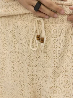 Pantalon beige en guipure coupe ample pourvu d'une taille élastiquée