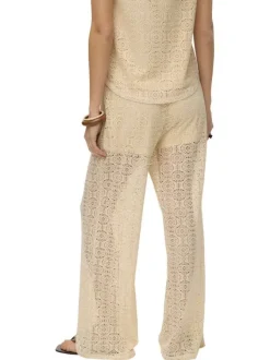 Pantalon beige en guipure coupe ample pourvu d'une taille élastiquée