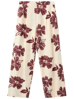 Pantalon beige à motifs pourvu d'une coupe large et de détails plissés
