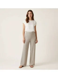 Pantalon beige uni pourvu d'une coupe large et d'une taille haute