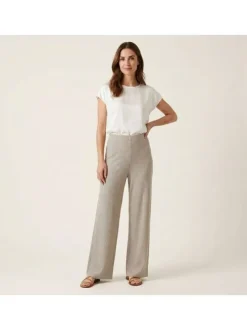 Pantalon beige uni pourvu d'une coupe large et d'une taille haute