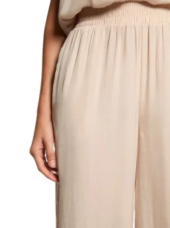Pantalon chino beige clair uni avec une coupe large et de multiples poches