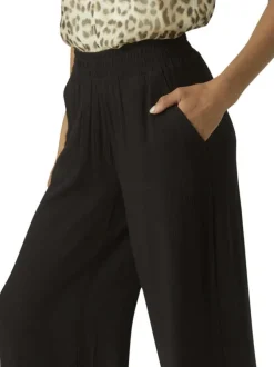 Pantalon Chino beige à taille élastiquée pourvu d'un motif abstrait