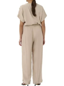 Pantalon chino beige uni pourvu d'une coupe bootcut et d'une taille haute
