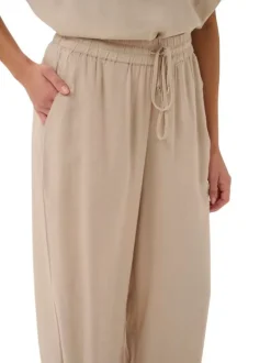 Pantalon chino beige uni pourvu d'une coupe bootcut et d'une taille haute