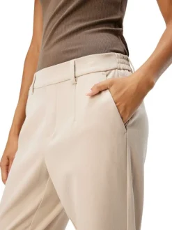 Pantalon chino beige uni pourvu d'une coupe slim et d'une taille intermédiaire