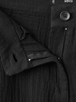 Pantalon chino en coton noir uni avec une coupe bootcut et des poches raglan