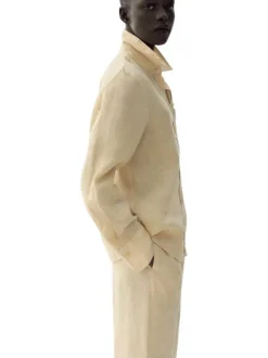 Pantalon chino en lin beige uni pourvu d'une coupe large et d'une taille haute