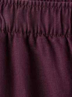 Pantalon chino en lin bordeaux uni pourvu d'une coupe large