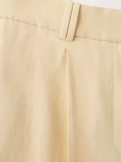 Pantalon chino jaune uni pourvu d'une coupe bootcut et d'une taille haute