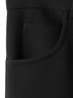 Pantalon chino noir uni avec une coupe bootcut à zip avec une agrafe