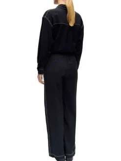 Pantalon chino noir uni pourvu d'une coupe bootcut et d'une taille élastiquée