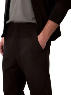 Pantalon chino noir uni pourvu d'une coupe slim et d'une taille elastiquée