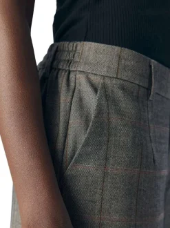 Pantalon chocolat à carreaux avec une coupe flare et une taille élastiquée