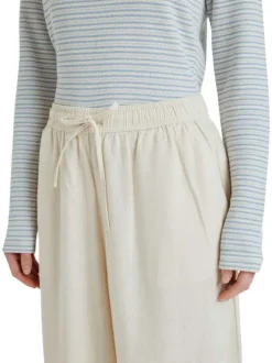 Pantalon écru à coupe ample pourvu de poches plaquées sur les côtés