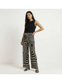 Pantalon écru et noir plissé pourvu d'un motif géométrique et d'une coupe ample