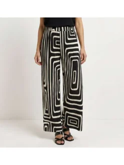 Pantalon écru et noir plissé pourvu d'un motif géométrique et d'une coupe ample