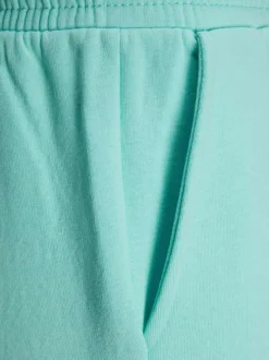 Pantalon de jogging Abbie en coton mélangé turquoise avec logo floqué sur la gauche