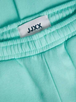 Pantalon de jogging Abbie en coton mélangé turquoise avec logo floqué sur la gauche