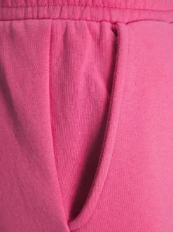 Pantalon de jogging Abbie rose en coton mélangé avec logo floqué ton sur ton