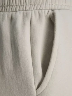 Pantalon de jogging en coton écru uni à coupe large et élastiqué aux chevilles
