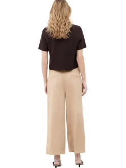 Pantalon en coton beige à coupe ample pourvu de poches à rabats