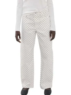 Pantalon en coton blanc à pois pourvu de passants pour la ceinture