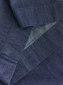 Pantalon en coton bleu pourvu d'une coupe évasée et d'une taille élastiquée