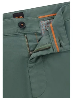 Pantalon en coton vert uni avec une coupe slim fit et des détails orange