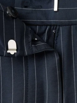 Pantalon marine à rayures blanches avec une coupe bootcut et 4 poches