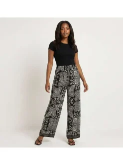 Pantalon noir à motifs pourvu d'une coupe droite et d'une taille élastiquée